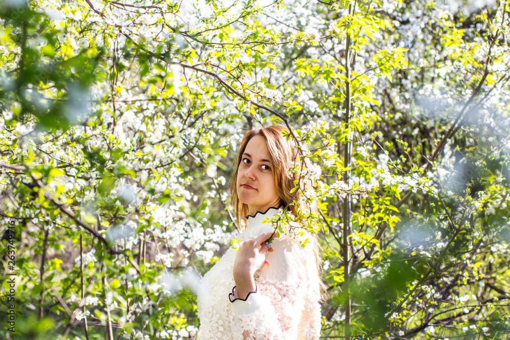 Pretty girl in the garden among flowering fruit trees. Pretty girl in the garden among flowering fruit trees.