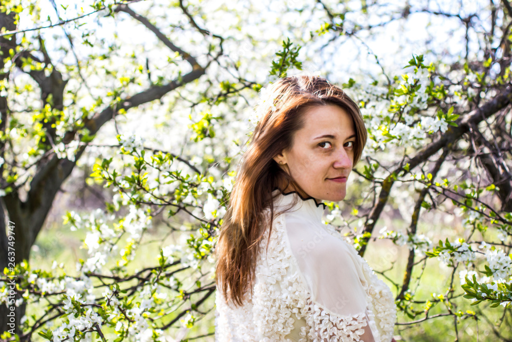 Pretty girl in the garden among flowering fruit trees. Pretty girl in the garden among flowering fruit trees.