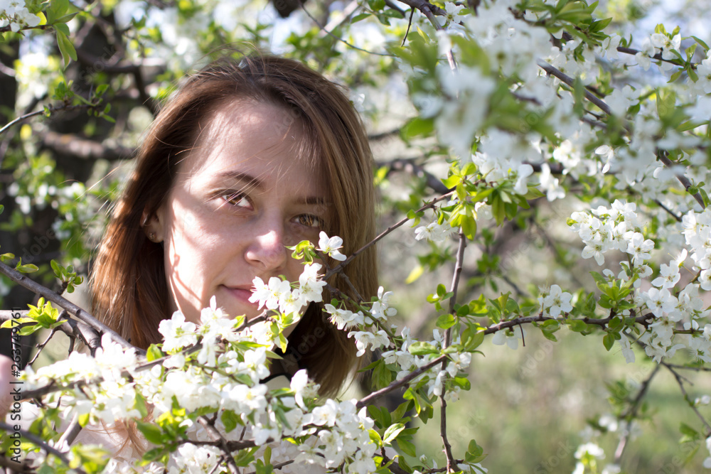 Pretty girl in the garden among flowering fruit trees. Pretty girl in the garden among flowering fruit trees.