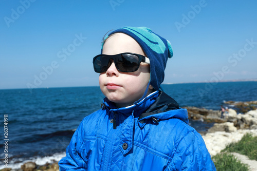 Kid posing on black sea background