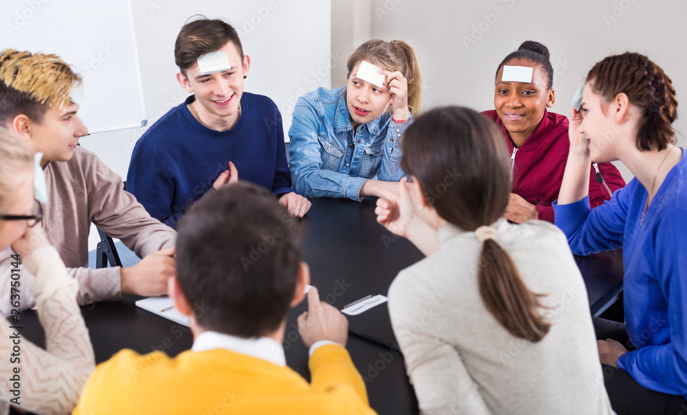 Fototapeta premium Fellow students playing guess-who game