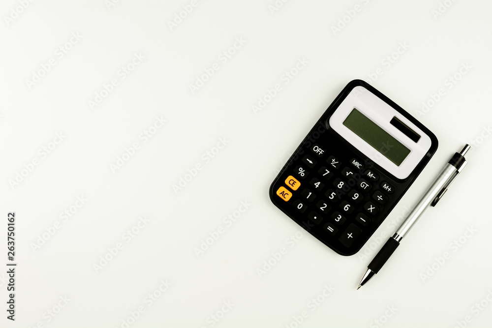calculator and and a pen on white table. - top view with copy space. calculator and and a pen on white table. - top view with copy space.