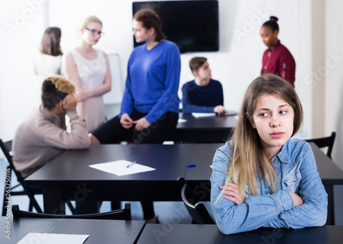 sad female student feeling uncomfortable at break between classes