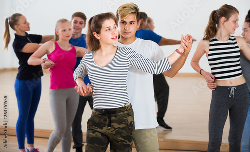 Group of teen dancing salsa in dance studio