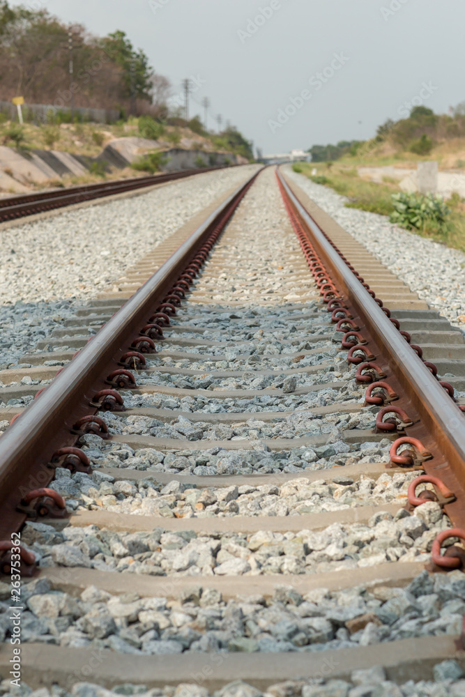 Naklejka premium Close up rail joint, rail anchor with perspective line from railroad tracks. Safety transportation. Avoid traffic jam. Public transportation for reduce green house effect. Saving energy and fuel.