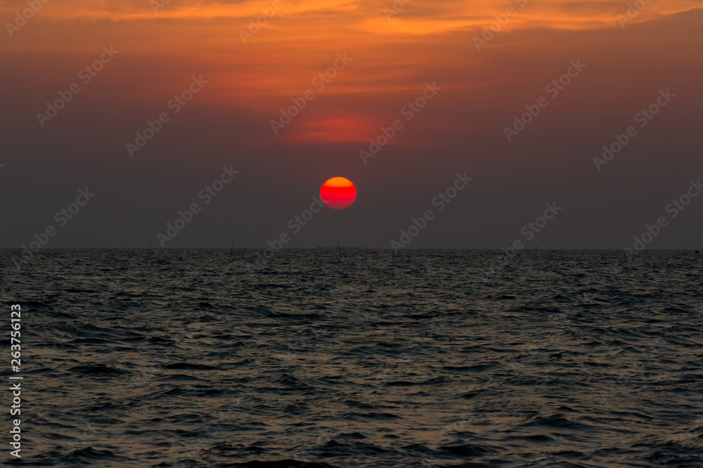 Bright sunset with large yellow sun under the sea surface. sunrise in the sea. Beautiful sunset above the sea. Tropical sunset on the beach. Bright sunset with large yellow sun under the sea surface. sunrise in the sea. Beautiful sunset above the sea. Tropical sunset on the beach.