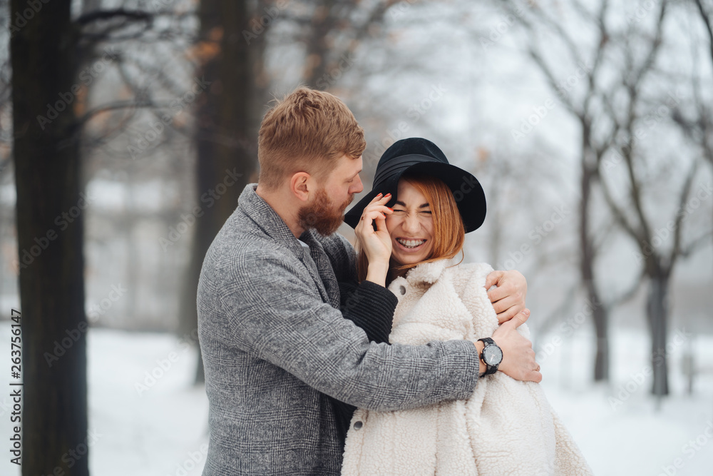 The guy and the girl are resting in the winter forest. The guy and the girl are resting in the winter forest.