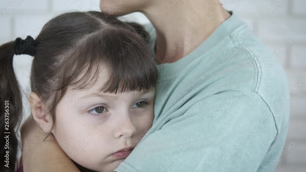 Mother hugs a sad child. Mother hugs the sad little daughter. Mother hugs a sad child. Mother hugs the sad little daughter.