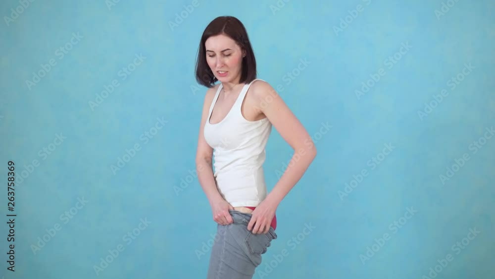 woman with has overweight problems, can not get into tight pants woman with has overweight problems, can not get into tight pants