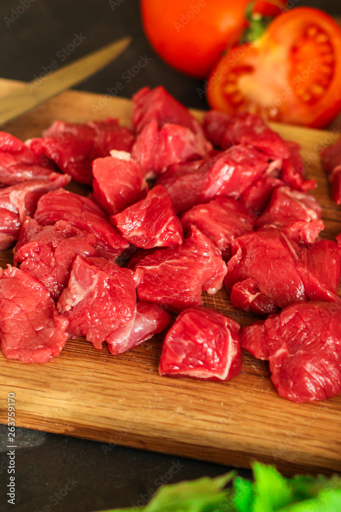 meat raw sliced, cut pieces on a cutting board, fresh. top view. food background