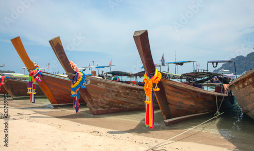 Fototapeta Naklejka Na Ścianę i Meble -  Sand beach with transparent water and traditional Thai boats. Thailand. Phi-Phi island.