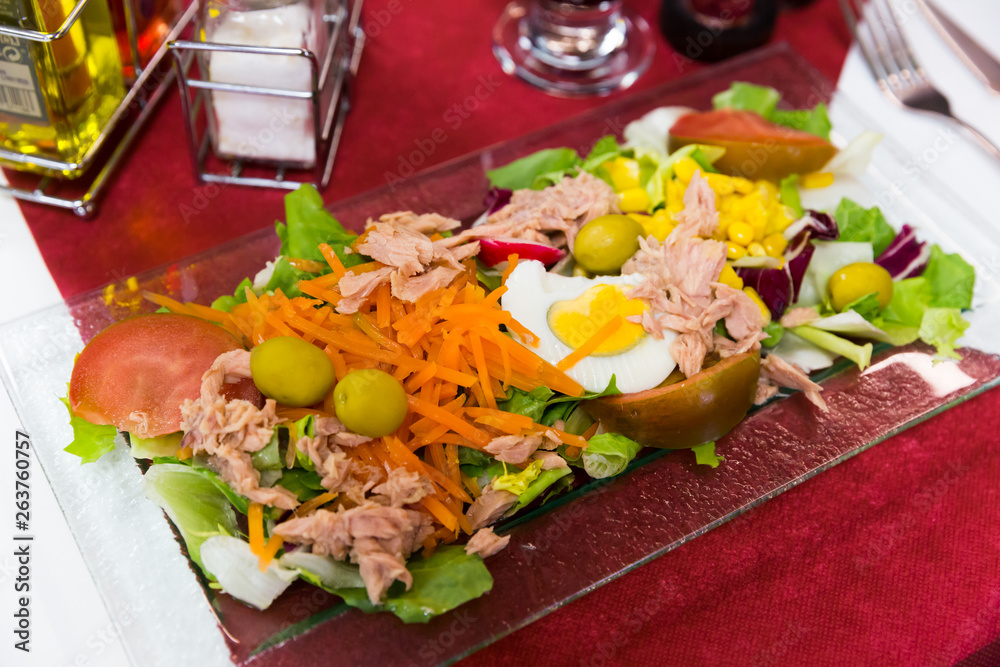 Salad with eggs, marinated tuna, vegetables and olives