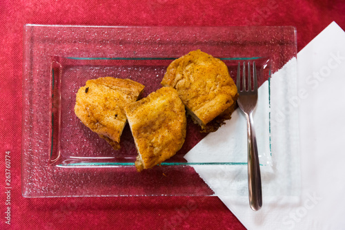 Top view of Madrid torrijas on burgundy background