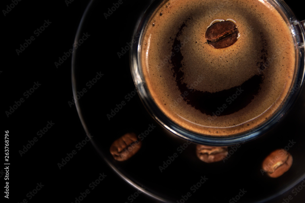 Coffee glass cup and coffee beans on saucer Coffee glass cup and coffee beans on saucer
