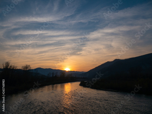 sunset in the mountains by the river Ukraine