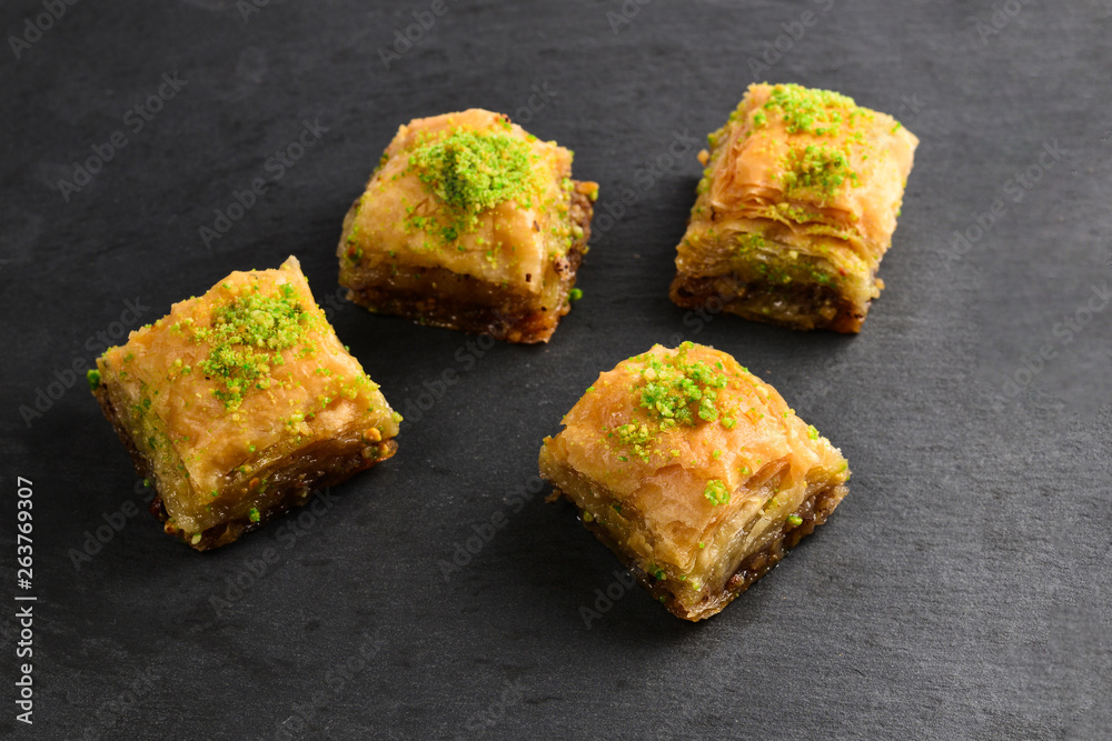 Pistachio baklava on a black plate. Dessert. Pistachio baklava on a black plate. Dessert.