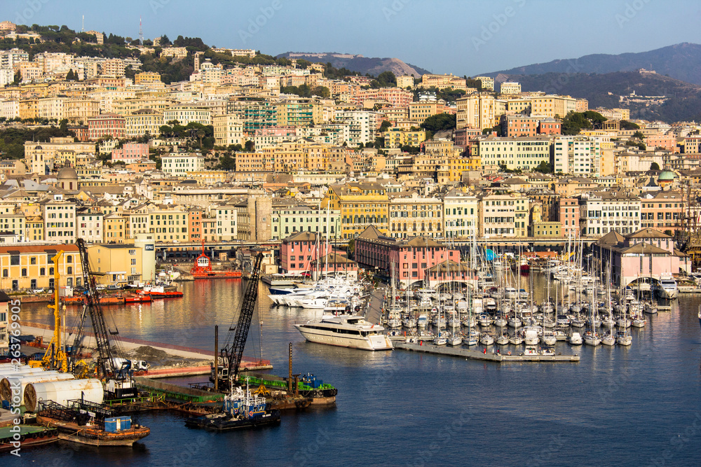 Mediterranean port,  cityscape in a bay, .yacht club and promenade, bunch of residential and historical multicolored buildings surrounded by mountains in Genoa (Genova), Italy, near mediterranean sea.