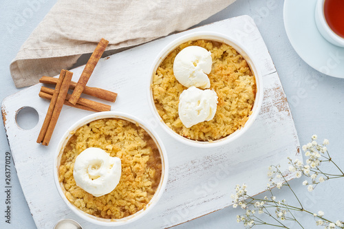 Apple crumble with ice cream, streusel, a flowers. Top view, close up photo