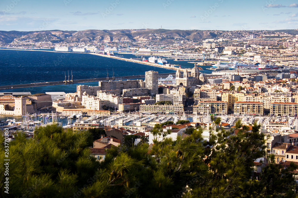 Unbelievable view panorama from observation deck near Notre Dame de la Garde on port,ships, bay, harbour and center of Marseilles, France with residential, historical, ancient buildings and monuments.
