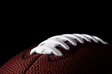 American football on dark background.