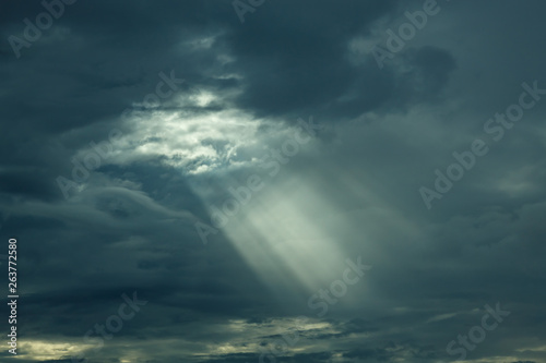 The sun's rays at sunset making their way through the clouds.