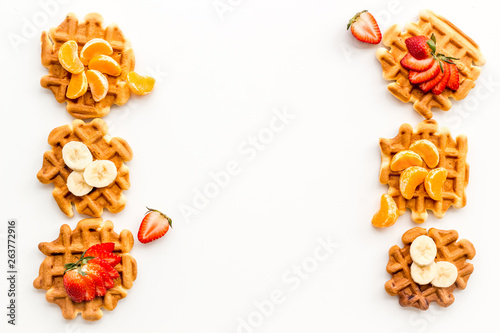 Traditional belgian waffles with fruit topings on white background top view mock up
