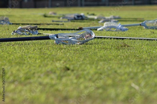Picture of lacrosse sticks on the field before the game.
