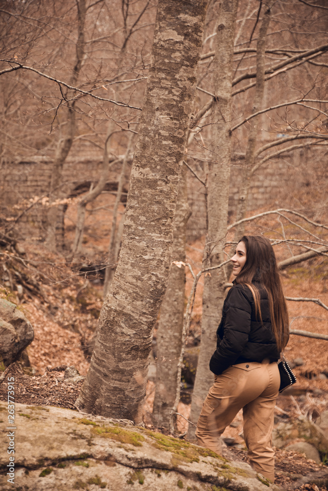 Brunette and happy girl in forest at San Fe del Montseny