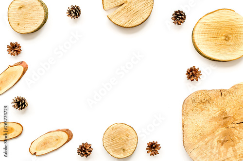 wooden saw cut and pine cone frame on white background to view mockup