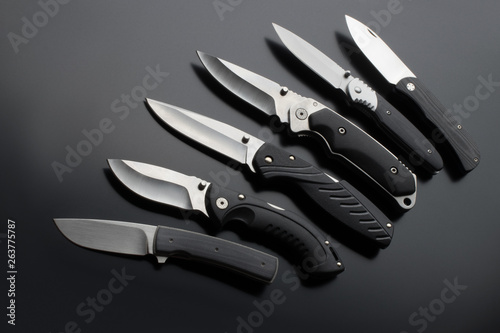 folding knives on a black background. pen knives on a dark background