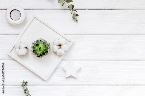 plant, candle, concrete figures and tray decorations for morden home office on white wooden background flat lay mock up