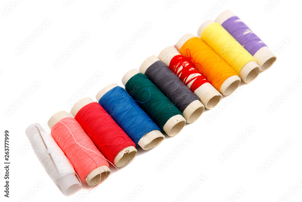 Many colorful thread spools on white background Many colorful thread spools on white background