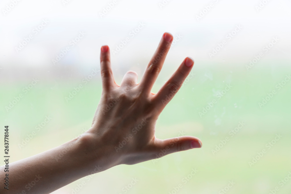 Hand of woman in gesture isolated on blurred background Hand of woman in gesture isolated on blurred background
