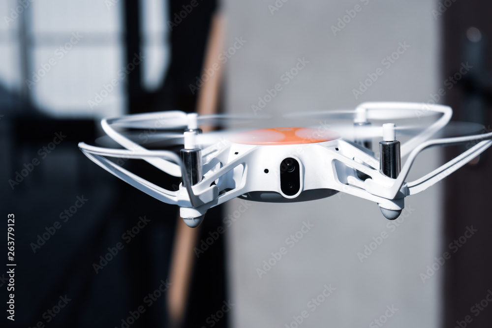 Quadcopter drone in flight with digital camera. Quadcopter drone in flight with digital camera.