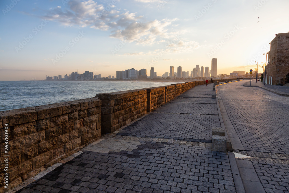 Beautiful view of the side walk on the ocean coast during a sunny sunrise. Taken in Jaffa Old City, Tel Aviv, Israel.