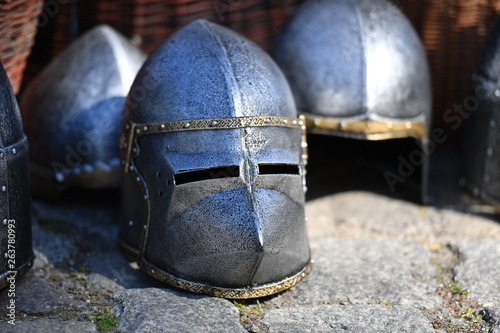 Shiny knight helmets on a traditional market.