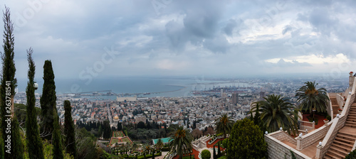 Beautiful panoramic view of Bahai Gardens and a city on the coast of Mediterranean Sea during a cloudy sunset. Taken in Haifa, Israel.