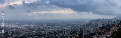 Beautiful panoramic view of a city on the coast of Mediterranean Sea during a cloudy sunset. Taken in Haifa, Israel. © edb3_16