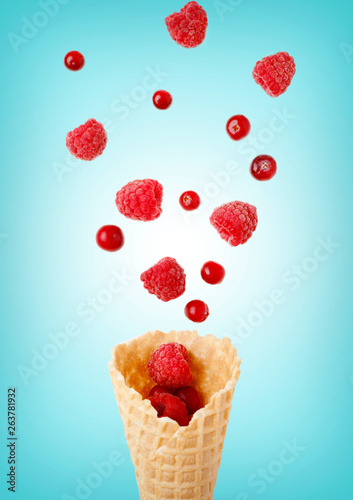 Wallpaper Mural Ice cream cone filled with .raspberry and cranberries on a blue  background. Frosen berries .fall out from a waffle cone. Summer concept. Torontodigital.ca