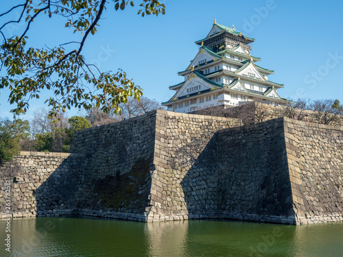 Scenery of Osaka Castle shining in the westering sun in early spring. photo