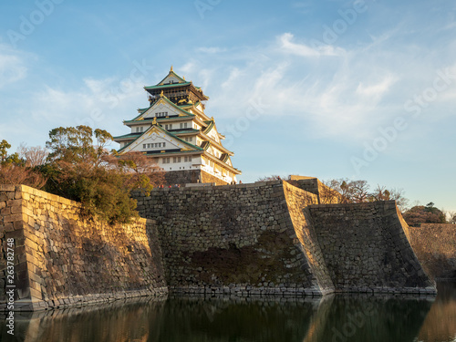 Scenery of Osaka Castle shining in the westering sun in early spring. photo