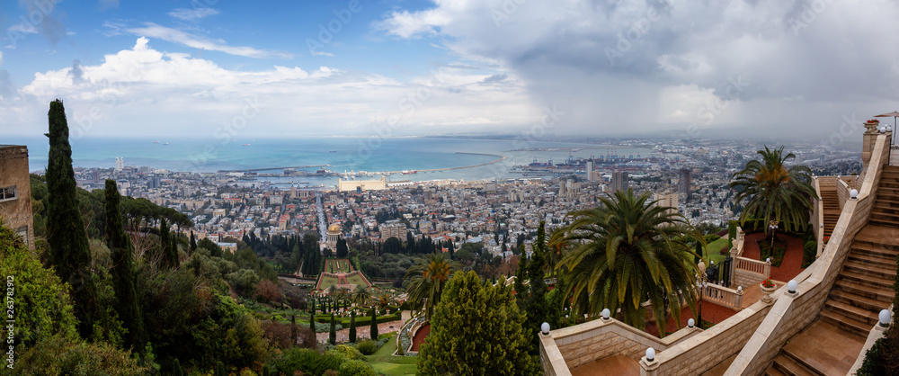 Beautiful panoramic view of Bahai Gardens and a city on the coast of Mediterranean Sea during a cloudy day. Taken in Haifa, Israel.