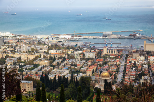 Beautiful view of Bahai Gardens and a city on the coast of Mediterranean Sea during a cloudy day. Taken in Haifa, Israel.