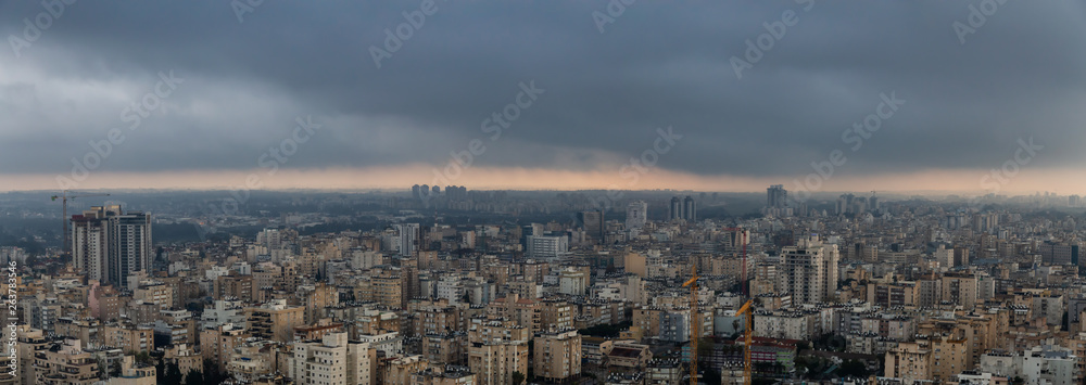 Obraz premium Aerial view of a residential neighborhood in a city during a cloudy sunrise. Taken in Netanya, Center District, Israel.