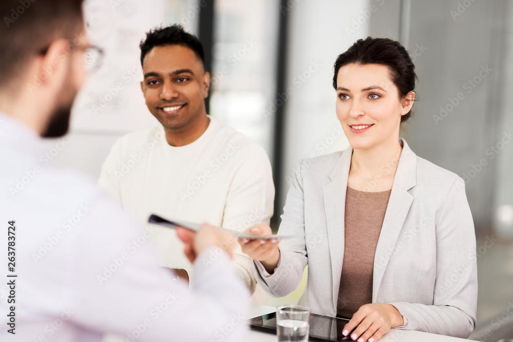 Fototapeta premium new job, hiring and employment concept - international team of recruiters having interview with male employee at office