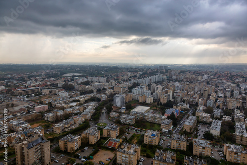 Aerial view of a residential neighborhood in a city during a cloudy sunrise. Taken in Netanya, Center District, Israel.