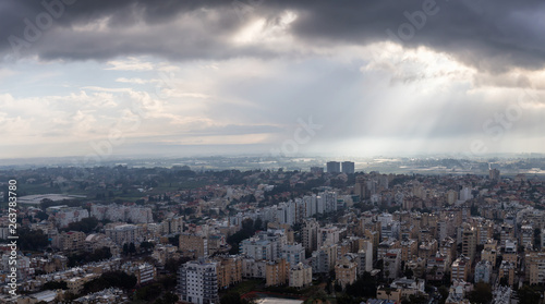 Aerial view of a residential neighborhood in a city during a cloudy sunrise. Taken in Netanya, Center District, Israel.