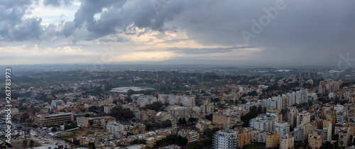 Aerial panoramic view of a residential neighborhood in a city during a cloudy sunrise. Taken in Netanya  Center District  Israel.