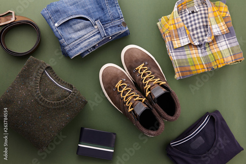 Fotografie Mens casual clothing outfits and accessories flat lay on olive green background,