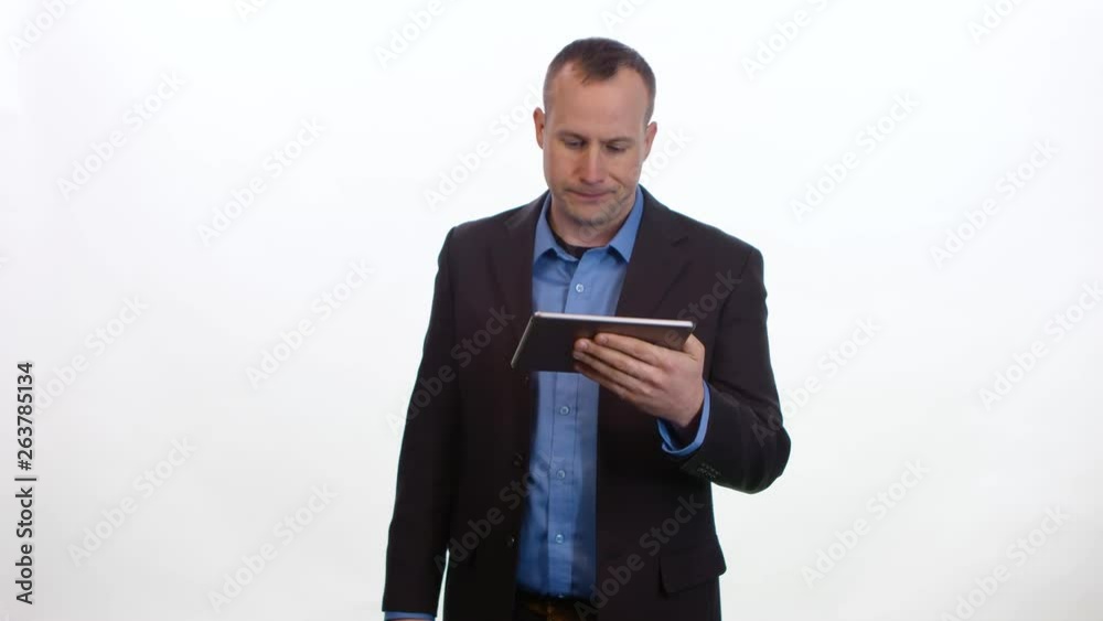 Businessman browses on a tablet and is disappointed with the results. Medium shot on white studio background. Businessman browses on a tablet and is disappointed with the results. Medium shot on white studio background.